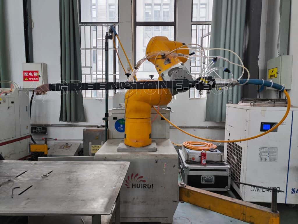 Internal laser cladding head integrated with Staubli industrial robot for automated metal repair and surface restoration