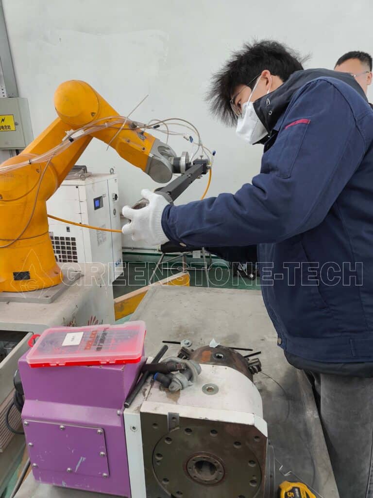 Engineer setting up and calibrating advanced laser cladding head for metal 3D printing and surface repair applications